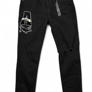 Black Amiri skinny jeans‎ with embroidered logo and distressed details